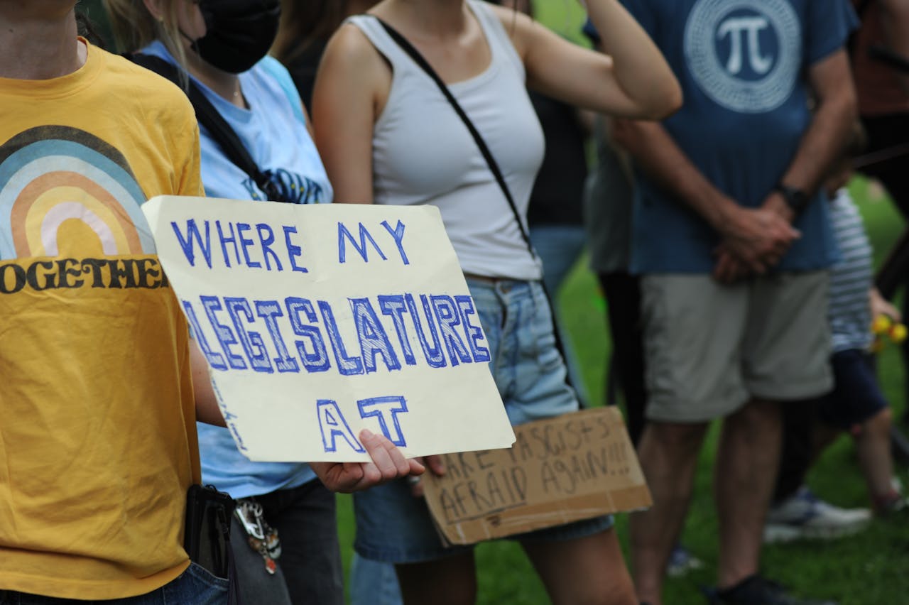 hero-img-02 A group of people in Baltimore, Maryland, protesting with handmade signs advocating for legislative change.